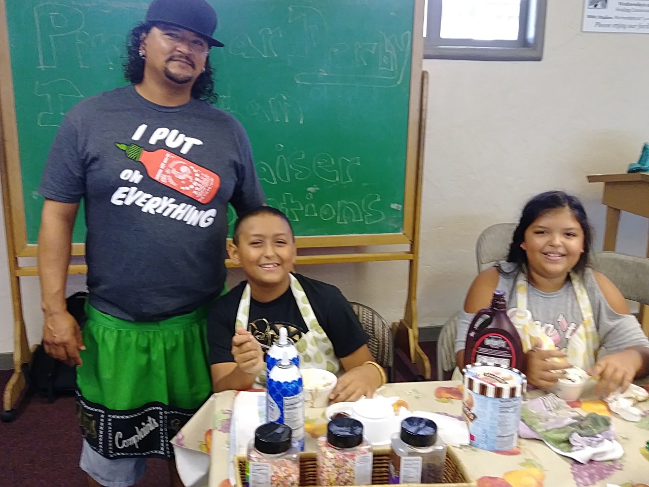 Adult and two kids at table with ice cream