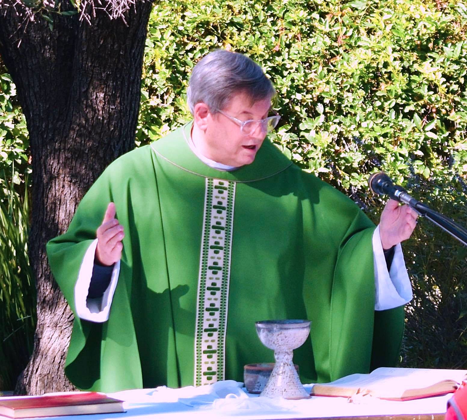 Priest standing outside officiating Sunday church service